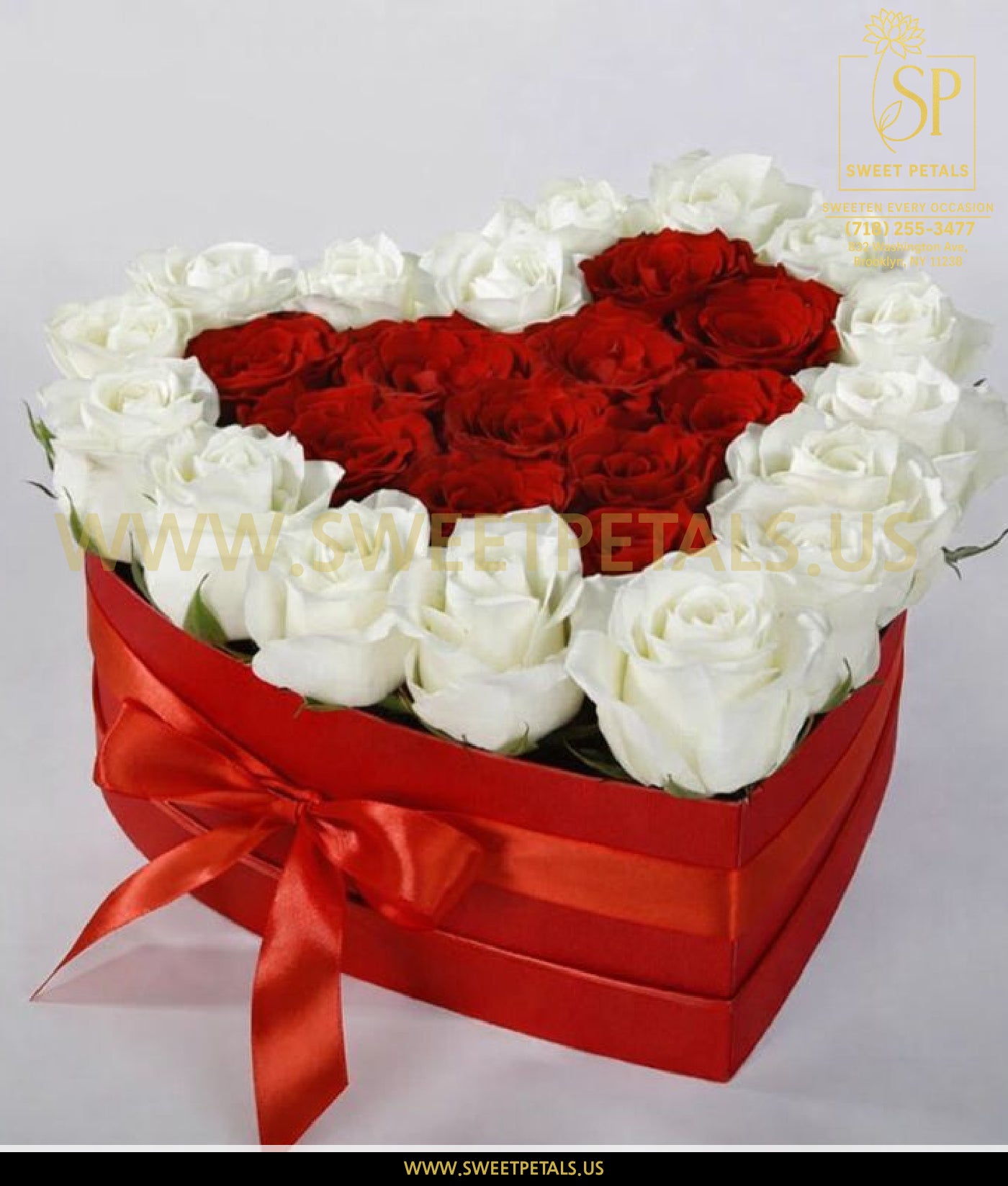 Heart shaped box for flowers filled with red and white roses, a romantic Valentine’s Day flower gift box and elegant flower valentine box.