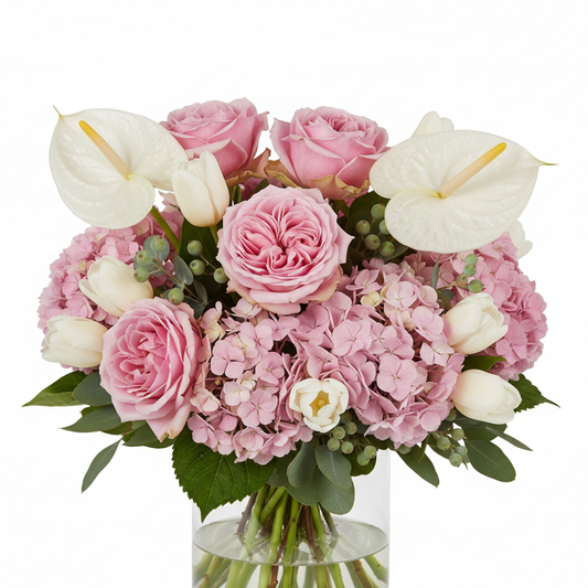 Close-up of pink roses hydrangea and white tulips in glass vase – SweetPetals NYC florist