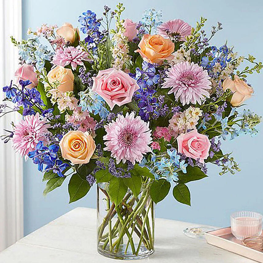 Radiant Blooms Pastel Vase Arrangement – Peach Roses, Pink Gerbera & Blue Delphinium in Glass Vase