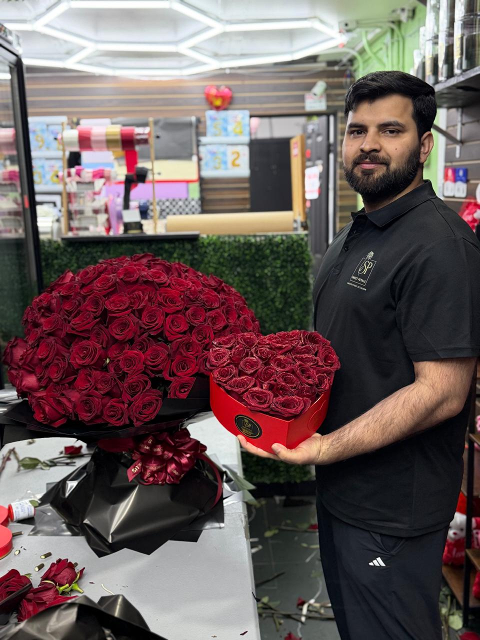 SweetPetals florist with a luxury 300 red rose arrangement for same-day delivery in NYC