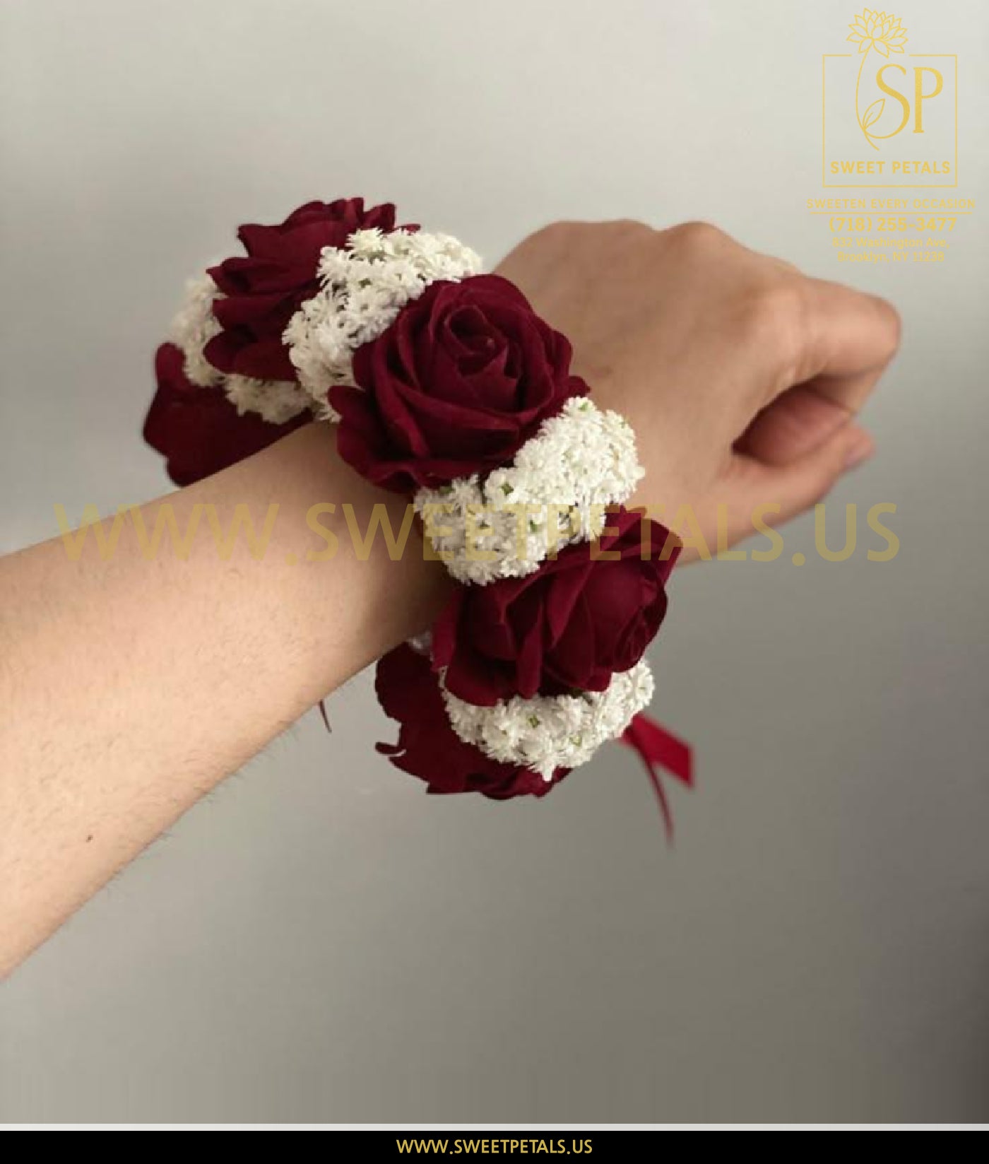 Red corsage with deep red flowers and white floral accents, elegant wrist design inspired by white orchid corsage, perfect red corsage near me for formal events.