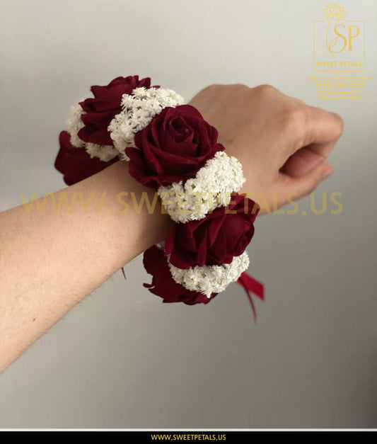Red corsage with deep red flowers and white floral accents, elegant wrist design inspired by white orchid corsage, perfect red corsage near me for formal events.