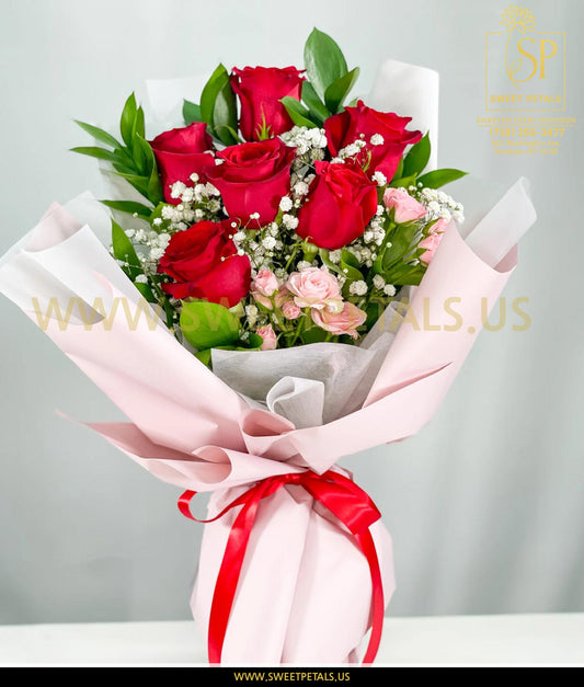 Romantic red and blush rose bouquet wrapped in soft pink paper with greenery and baby’s breath, perfect flower bouquet for Valentine Day and romantic gifting.