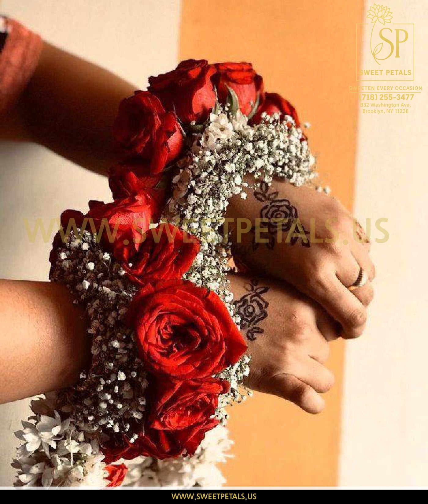 Wrist corsage with red roses and delicate filler flowers, showcasing a burgundy corsage made with spray rose corsage design for a formal occasion.