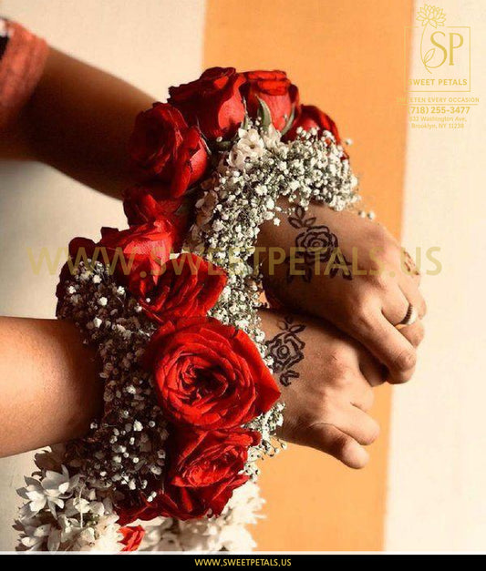 Wrist corsage with red roses and delicate filler flowers, showcasing a burgundy corsage made with spray rose corsage design for a formal occasion.