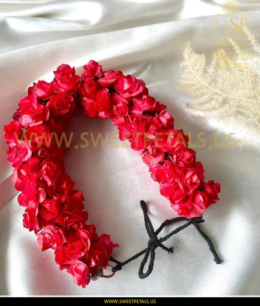 A wrist corsage featuring fresh red roses arranged on a bracelet, showcasing a fresh flower wrist corsage suitable for same day wrist corsage delivery.