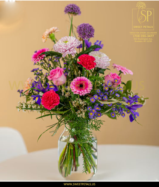 Bright springtime flower arrangement in clear vase named Spring Sunshine inspired by eternal sunshine