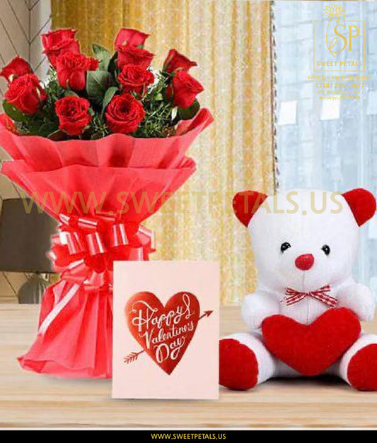 Bouquet of red roses, 'Happy Valentine's Day' card, and teddy bear with heart on a table.