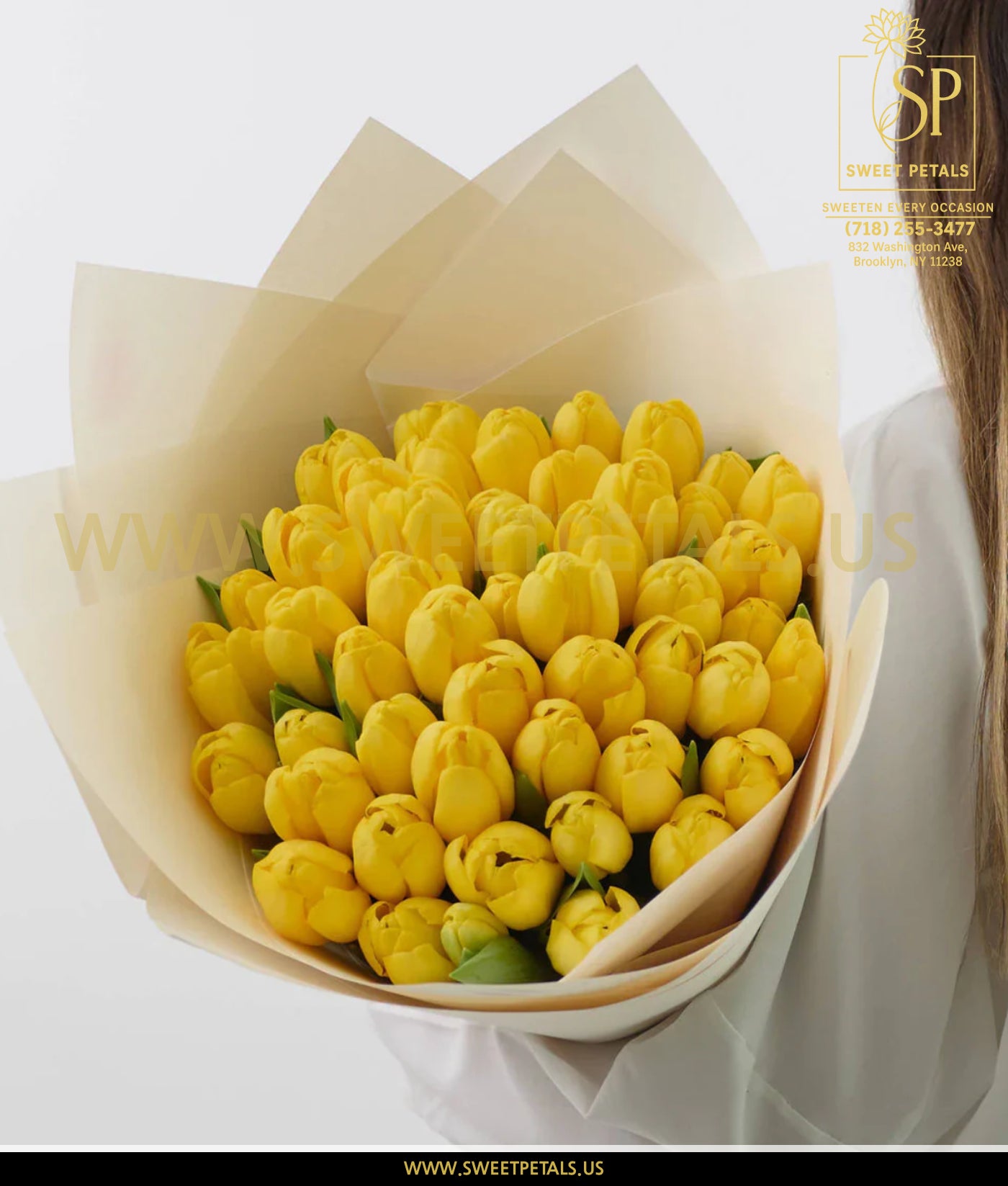 Bouquet of fresh yellow tulips wrapped in soft paper, perfect for Mother's Day flowers