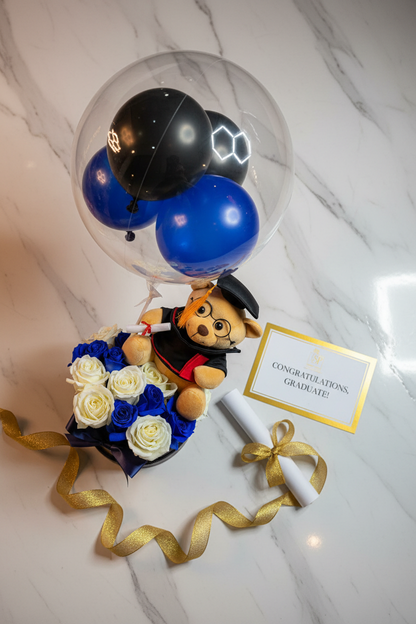 Flat lay luxury graduation gift set with teddy bear balloon and blue roses on marble – SweetPetals gift delivery