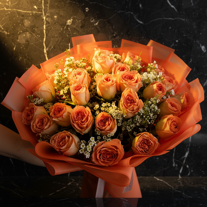 Close-up of peach-orange garden roses and white waxflower in coral wrap on dark marble with golden glow – SweetPetals ember glow luxury rose bouquet
