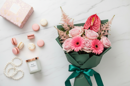 Pink blooms bouquet flat lay with gift box and macarons – SweetPetals luxury flower delivery NYC