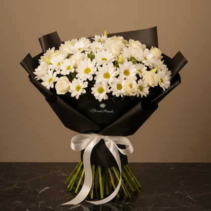 Close-up of white daisy chrysanthemums white spray roses and lisianthus in black hat box with white ribbon – SweetPetals luxury white flower arrangement