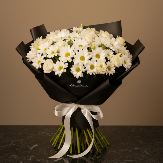 Close-up of white daisy chrysanthemums white spray roses and lisianthus in black hat box with white ribbon – SweetPetals luxury white flower arrangement
