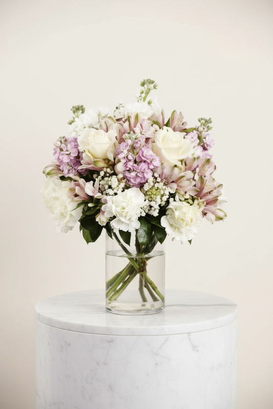 White rose and lavender stock vase on marble pedestal editorial – SweetPetals NYC florist