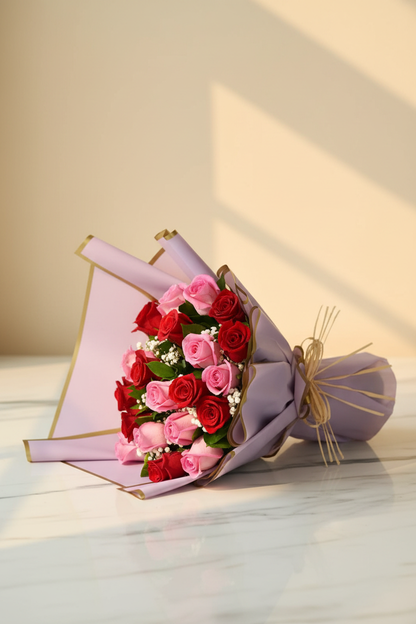 Red and pink rose symphony bouquet on white marble golden hour editorial – SweetPetals NYC florist