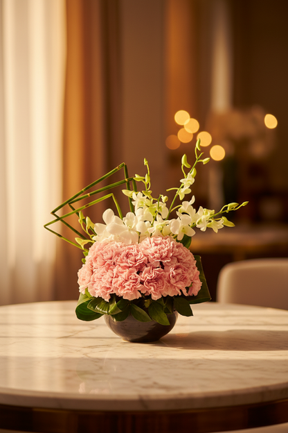 Pink carnation and white orchid vase arrangement in golden hour marble lifestyle setting – SweetPetals NYC