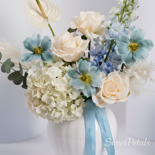 Close-up blue cosmos white hydrangea cream roses anthurium in ceramic vase – SweetPetals premium flowers NYC