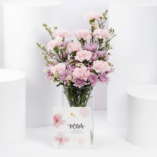 Pink carnations and purple chrysanthemums in glass vase with M&M greeting card – SweetPetals NYC florist