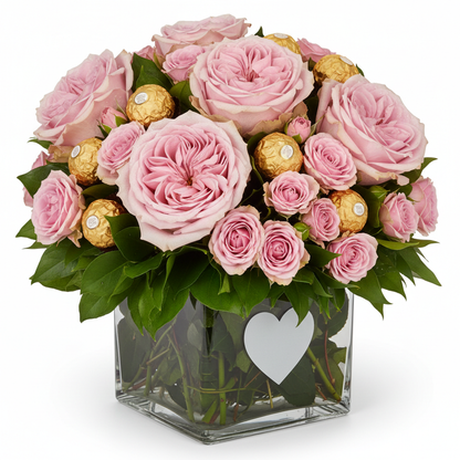 Close-up of pink roses and Ferrero Rocher in heart glass vase – SweetPetals NYC florist