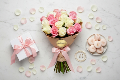 Flat lay pink white rose bouquet with gift box and macarons on marble — SweetPetals luxury flower gift USA